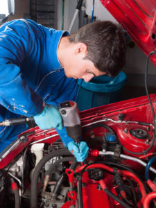 A mechanic works on a European car.